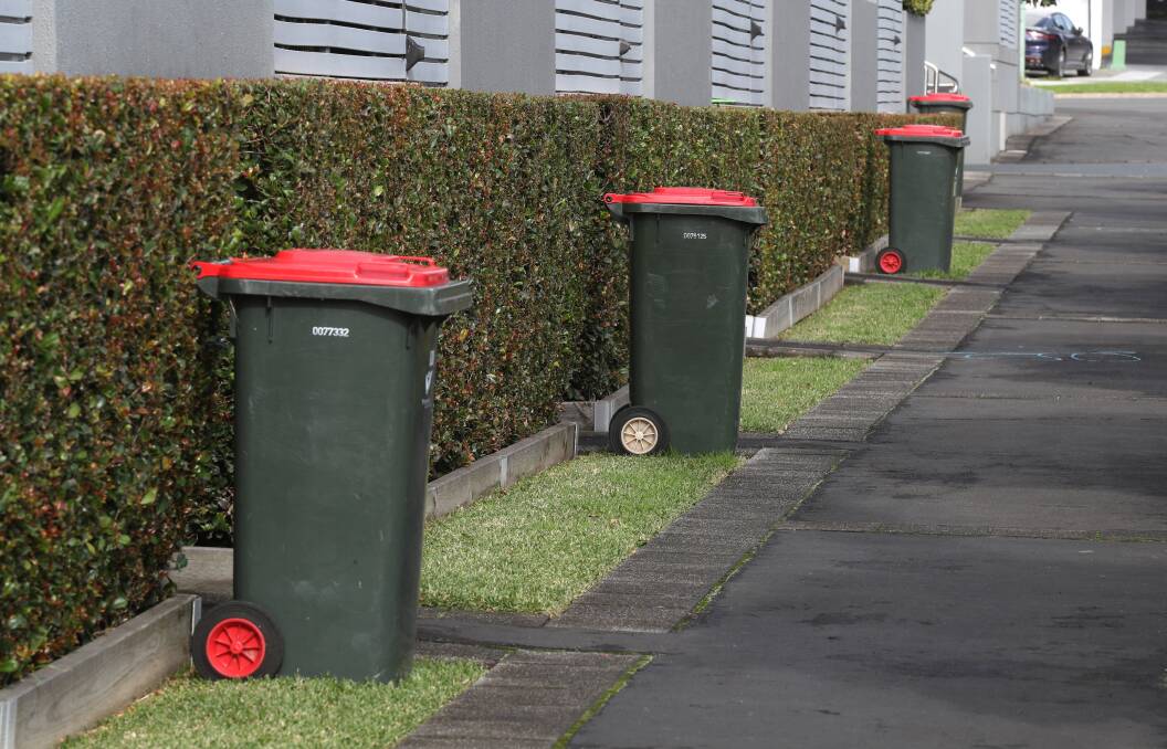 Red lid bins out for collection on Tuesday in Wollongong. Picture by Robert Peet