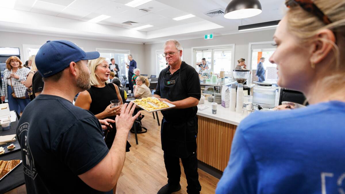 The Plant Room supported worker Brett Grimson serves up food at the cafe's official opening. Picture supplied