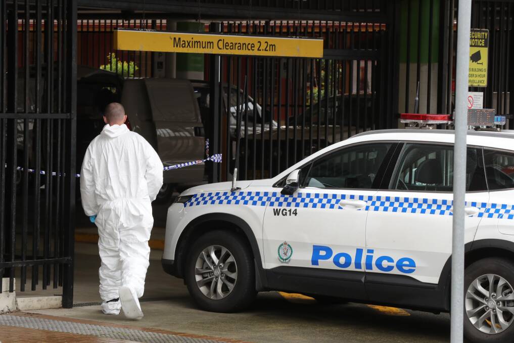 Police examine a crime scene at the Wollongong train station car park. Pictures by Robert Peet
