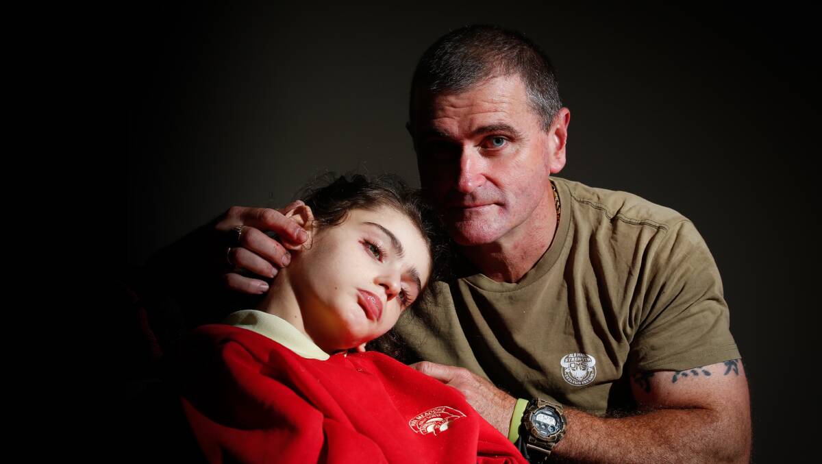 Illawarra father Nathan with daughter Aurora, who waited several hours in the emergency department. Picture by Anna Warr.