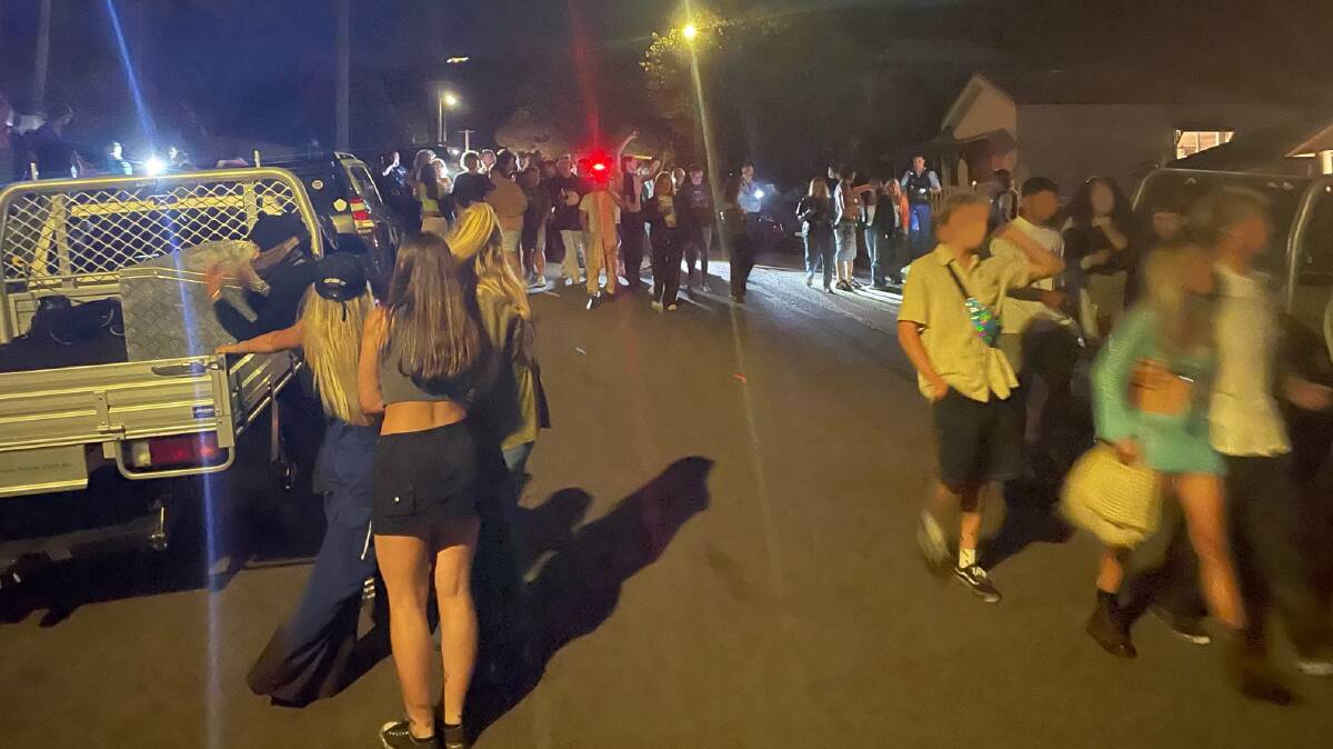 Police herd young partygoers away from the scene of the bash.