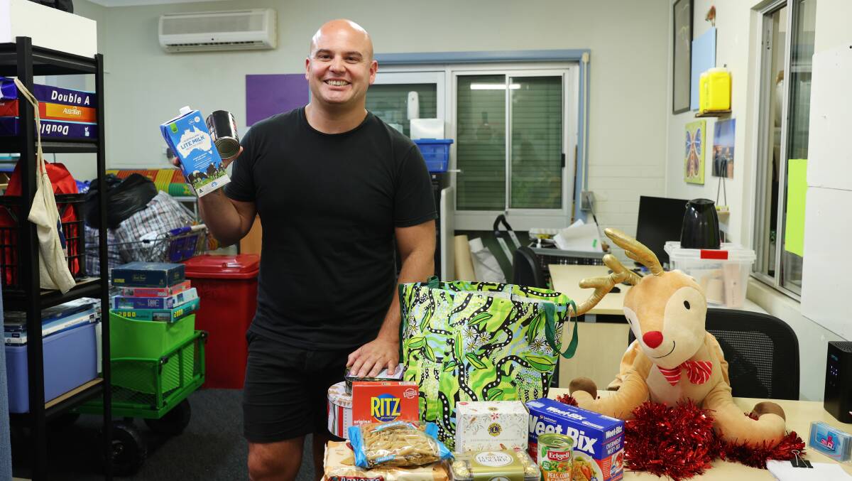 Warrawong Residents Forum manager Ash Castro with some of the items he hopes to fill Christmas hampers with. Picture by Sylvia Liber