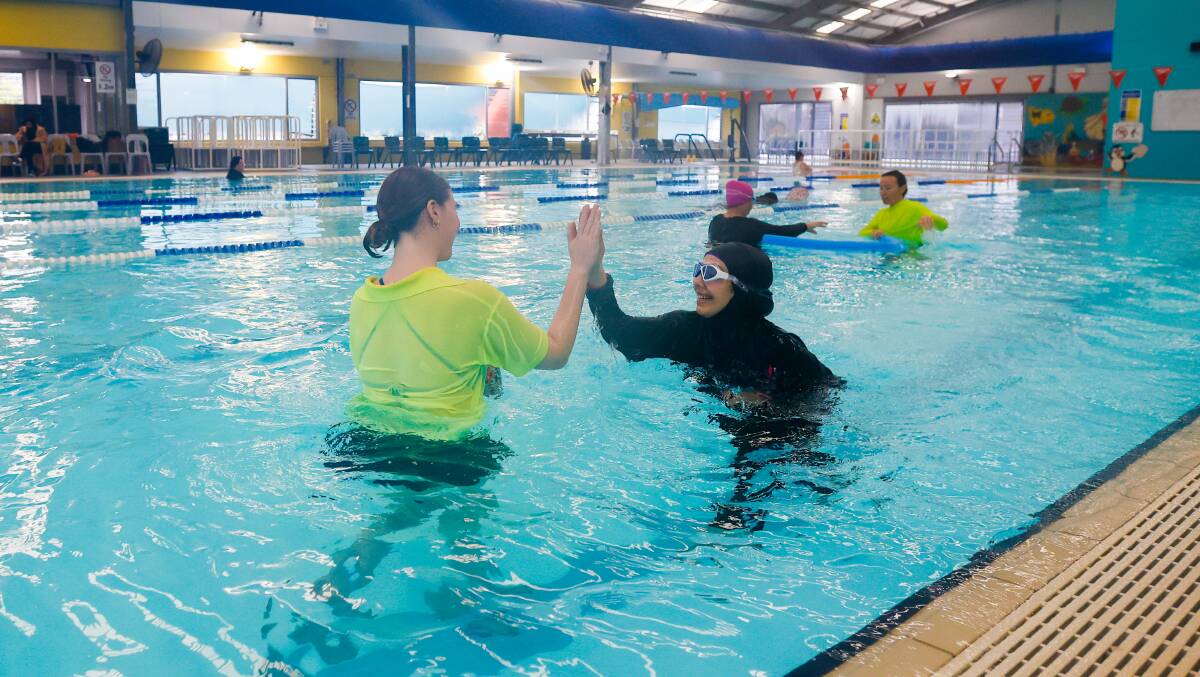 Shayma Omar high-fives an instructor after swimming without a flotation device. Picture by Anna Warr
