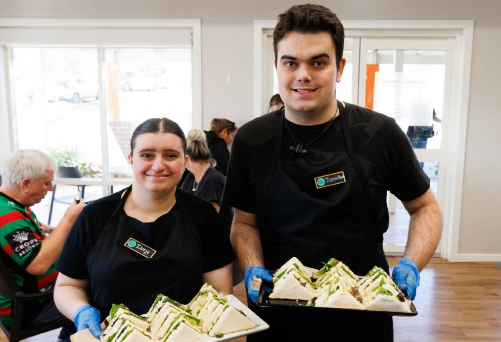 The Plant Room supported workers Izzy and Jonathon offer up trays of sandwiches. Picture supplied