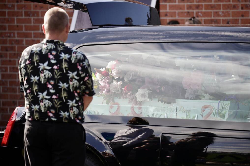 A loved one stands beside Lily's casket. Picture by Adam McLean.
