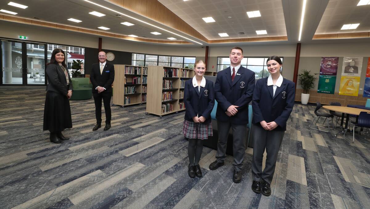 Holy Spirit College assistant principal Lisa Costabile and principal Christopher Agnew with captains Eva Georgievski, Jackson Smith and Tallulah Rogers in the new library. Picture by Robert Peet