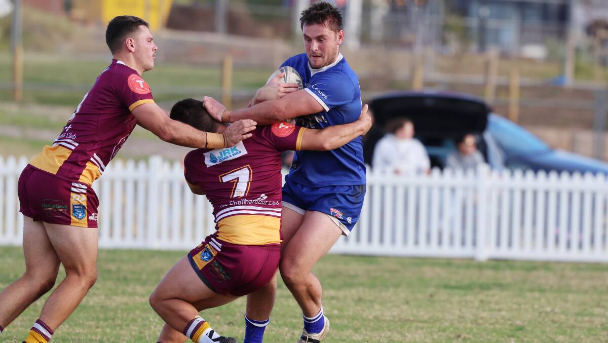 Gerringong's Jake Taylor tries to break free from a Shellharbour tackler. Picture by Sylvia Liber