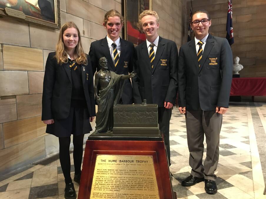 Smith's Hill High School's NSW debating champion team of Arin Tornyi-Aydin, Henry Kocatekin, Elinor Stephenson and Tommy Polden show off their trophy.