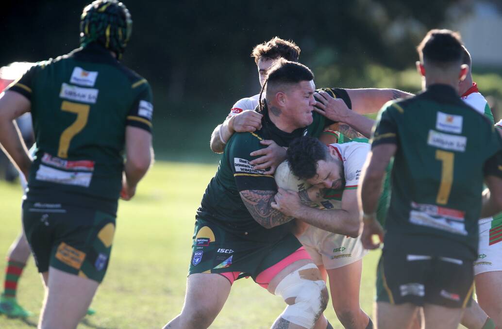 Jamberoo defenders try to tackle Stingrays forward Jake Kamire. Picture by Sylvia Liber