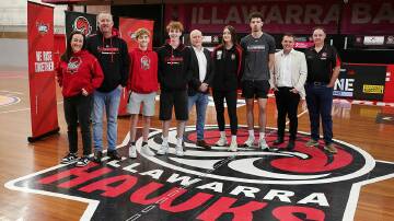 Illawarra Hawks CEO Stu Taggert and Illawarra Basketball Association executive general manager Nathan Loveday were joined by local players at the Snakepit on Friday to witness the signing of the two organisations historic partnership. Picture by Sylvia Liber