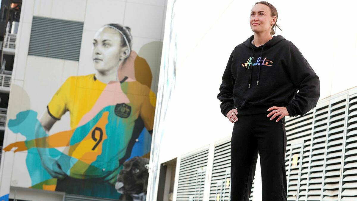 Caitlin Foord near the mural of herself outside the Keira Building in Wollongong. Picture by Adam McLean