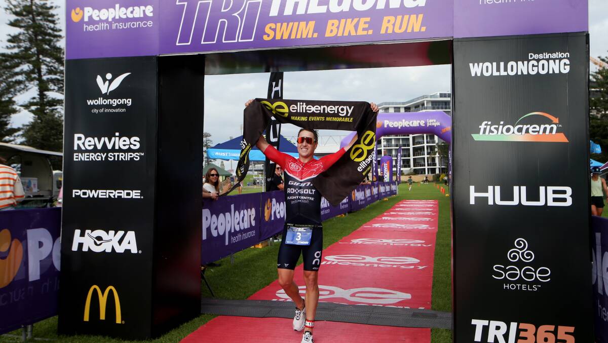 Figtree endurance triathlete Ben Allen celebrates after winning the triathlon event at the Tri TheGong Festival on Sunday. Picture by Sylvia Liber