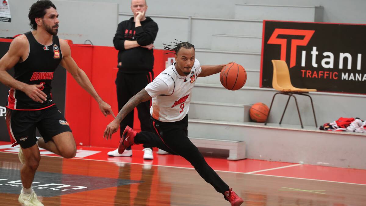 Justin Robinson dribbles past Will Hickey during Illawarra Hawks training on Tuesday. Picture by Robert Peet