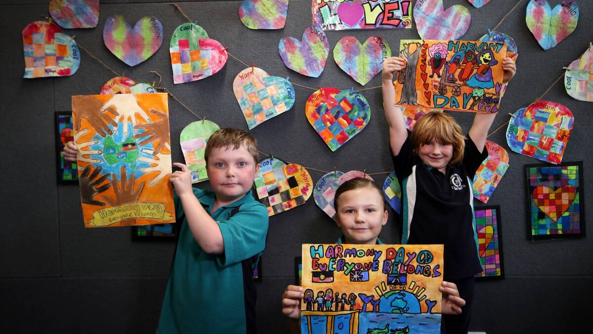 Hayes Park Public School students Chase Findlay, Ava Allison and Grace Harmony Collins show off their poster art. Picture: Sylvia Liber. 