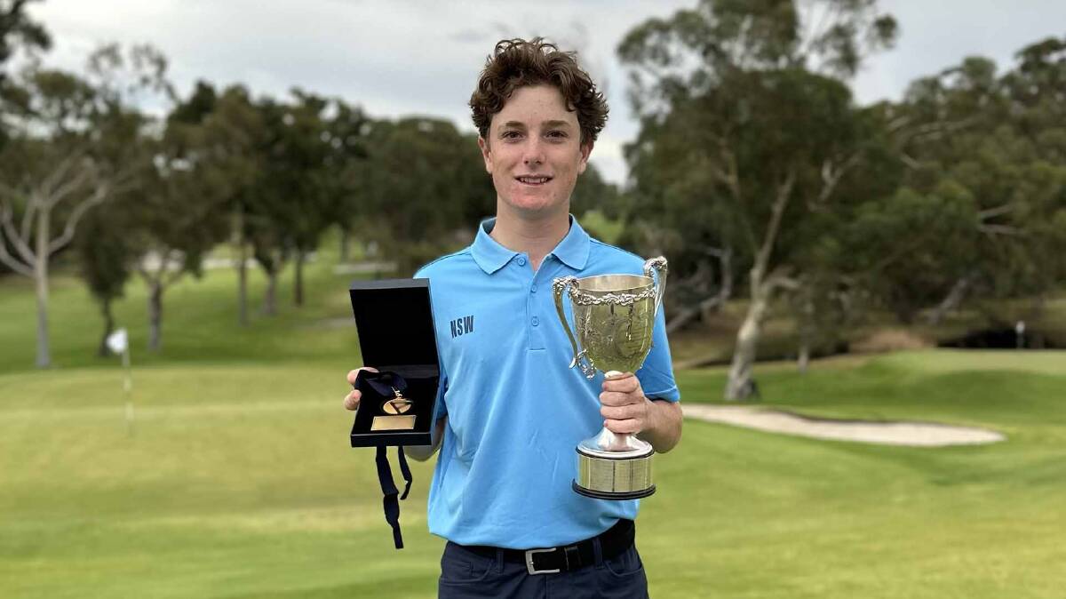 Sam Cascio holds aloft his trophies after winning the Australian Junior Amateur Championships in Perth. Picture Dave Tease