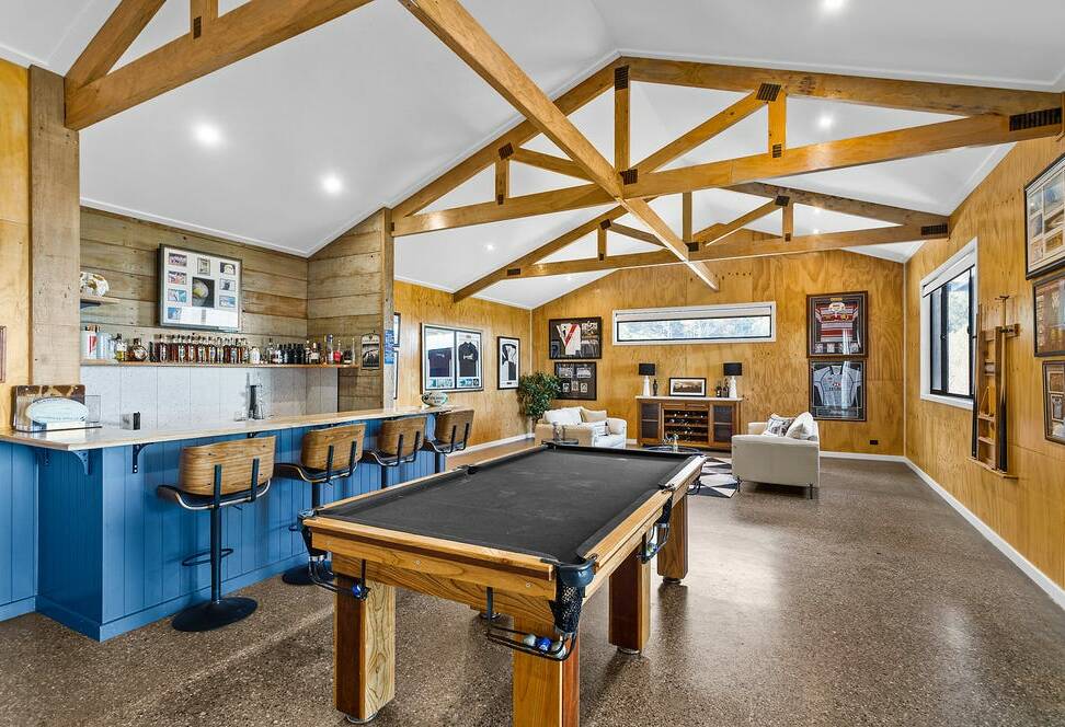 Features include a 13-metre by 17-metre industrial workshop, and a 'man cave' with pool table and bar. Picture: Supplied