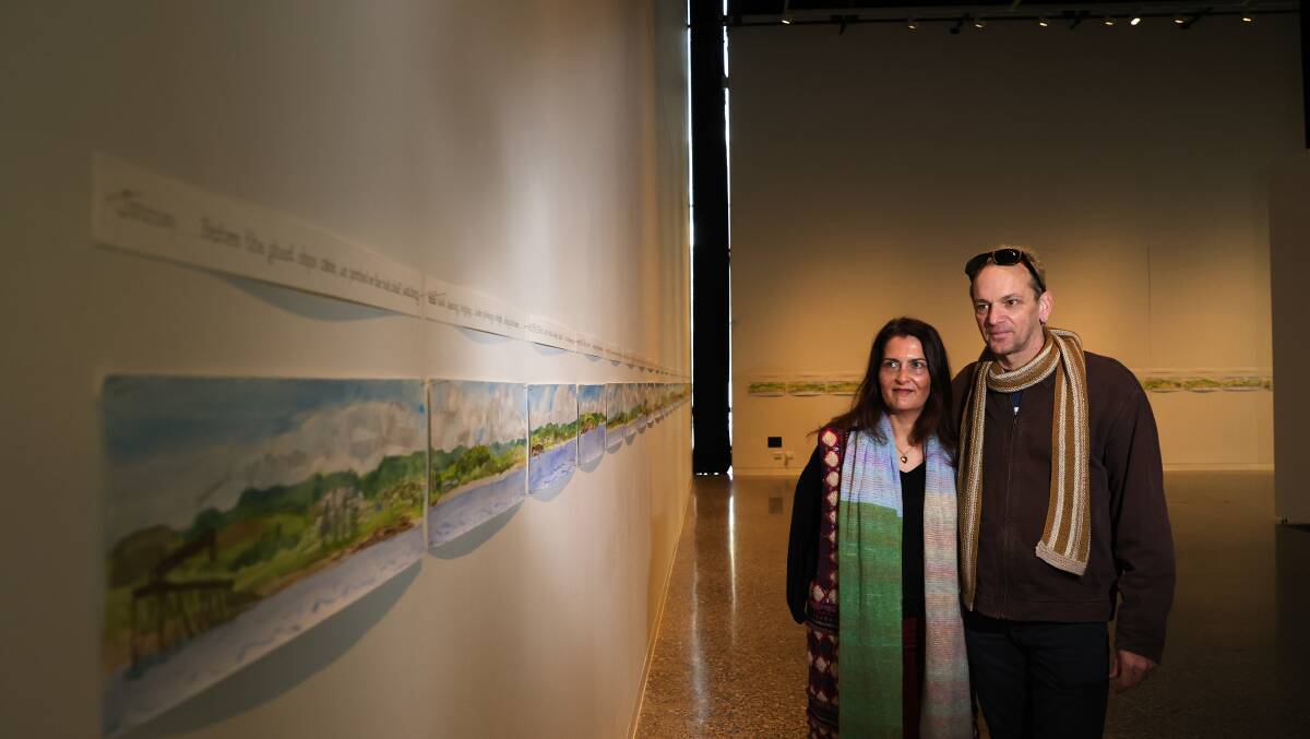 Two visitors view the watercolour at the City+Sea exhibition. Picture by Sylvia Liber