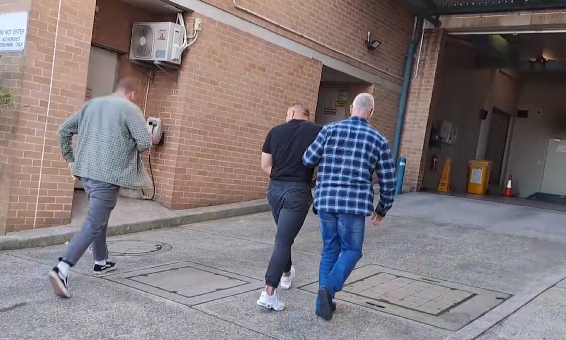 Kaan Berk was arrested at a Wollongong gym and escorted to the police station by Raptor detectives. 