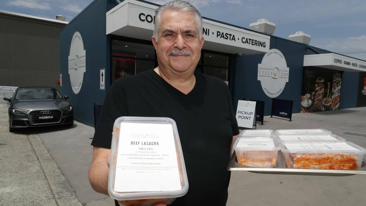 Claude Guido outside the new Villa D'Oro site in Fairy Meadow holding takeaway lasagna. Picture by Robert Peet