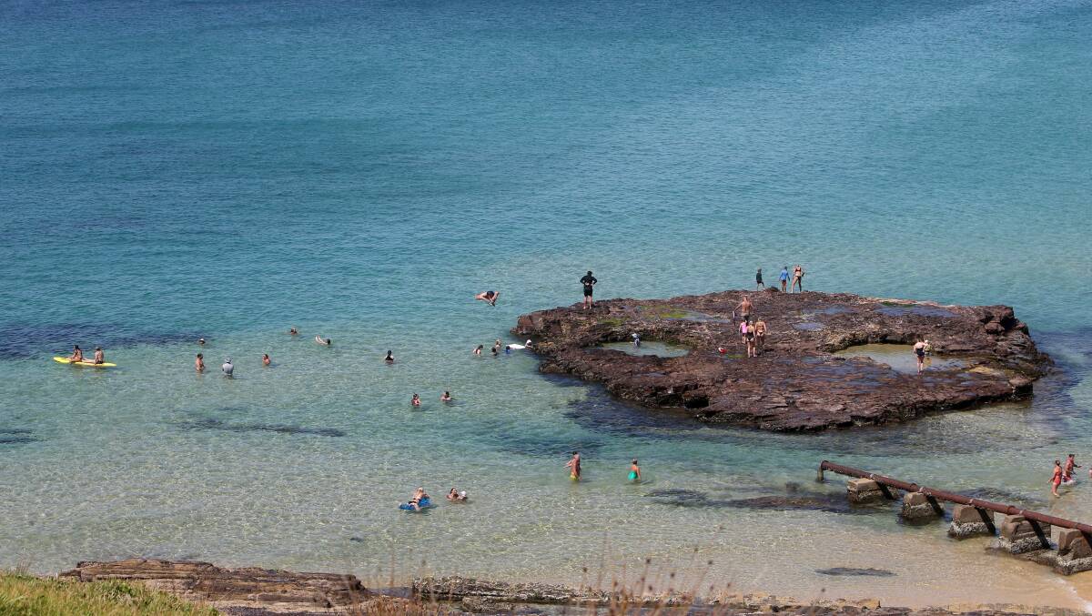 Beachgoers enjoy the water at Port Kembla Beach. 