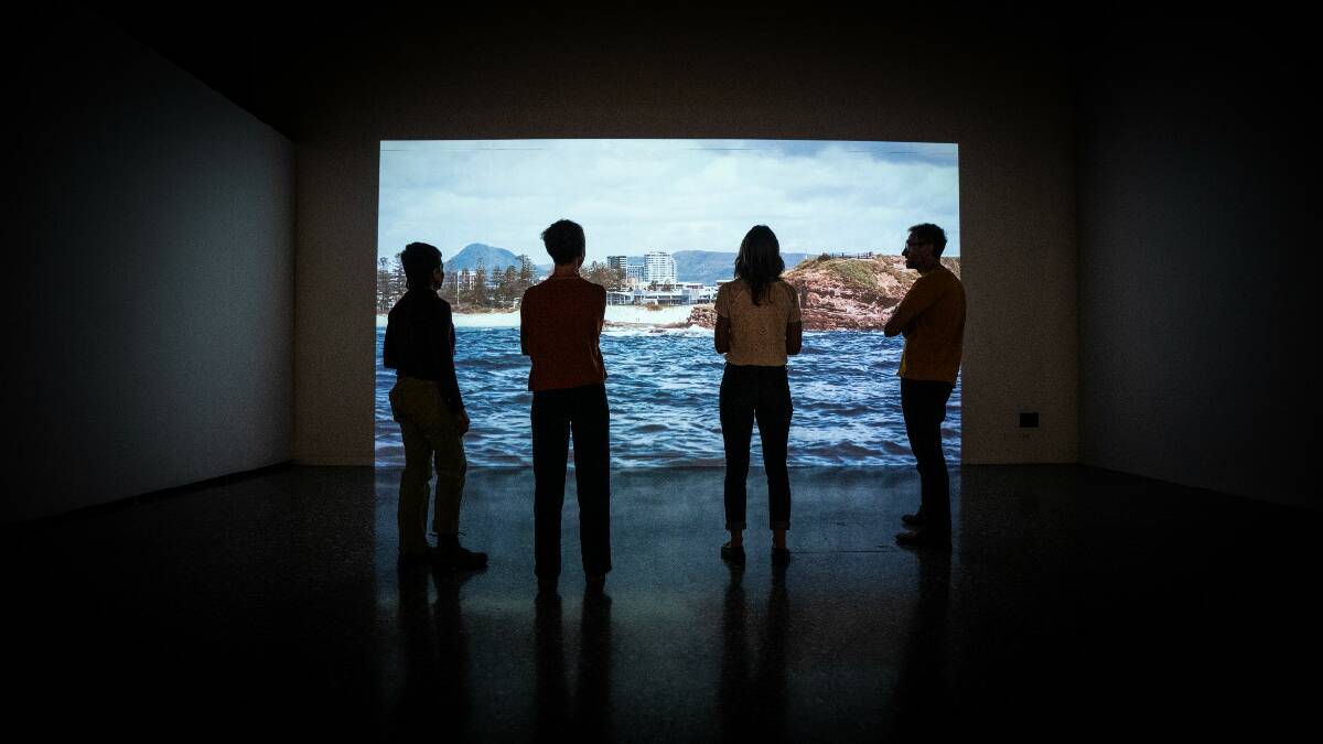 The four researchers behind City+Sea watch their film in the UOW Gallery. Picture supplied
