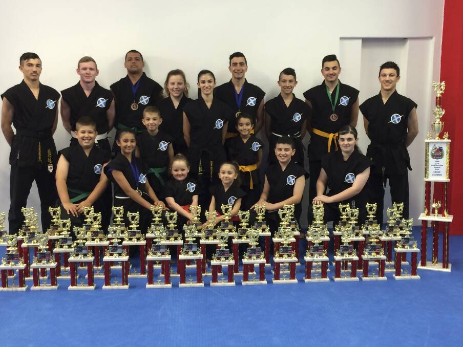 Members of Xtreme B-Force Martial Arts with the trophies they won at the ISKA World Cup at Liverpool last month.