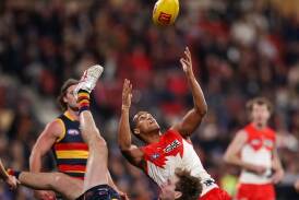 Joel Amartey of the Swans marks over Crows' Max Michalanney before an early finish at Adelaide Oval. (Matt Turner/AAP PHOTOS)