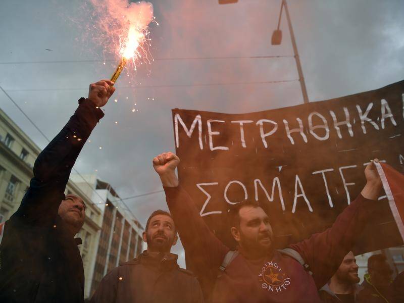 Protesters have rallied in Greece to demand justice and more pay a year after a deadly train crash. (AP PHOTO)