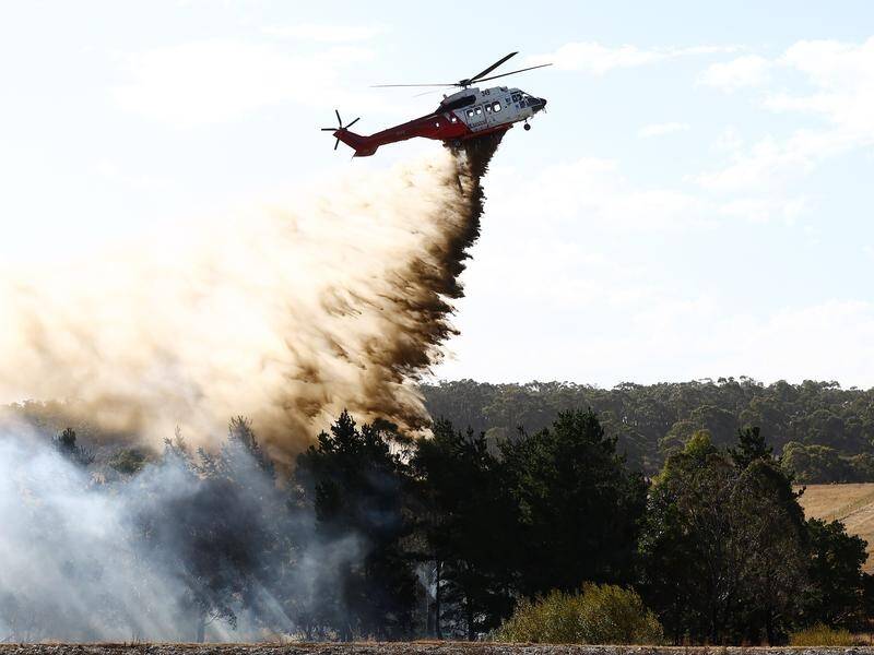 Helicopters helped crews contain blazes in Victoria during catastrophic fire danger conditions. (Con Chronis/AAP PHOTOS)