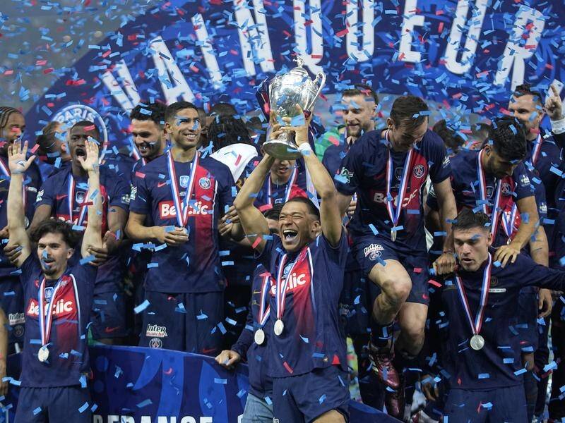 Departing in style, Kylian Mbappe raises the trophy after PSG won the French Cup final aginast Lyon (AP PHOTO)