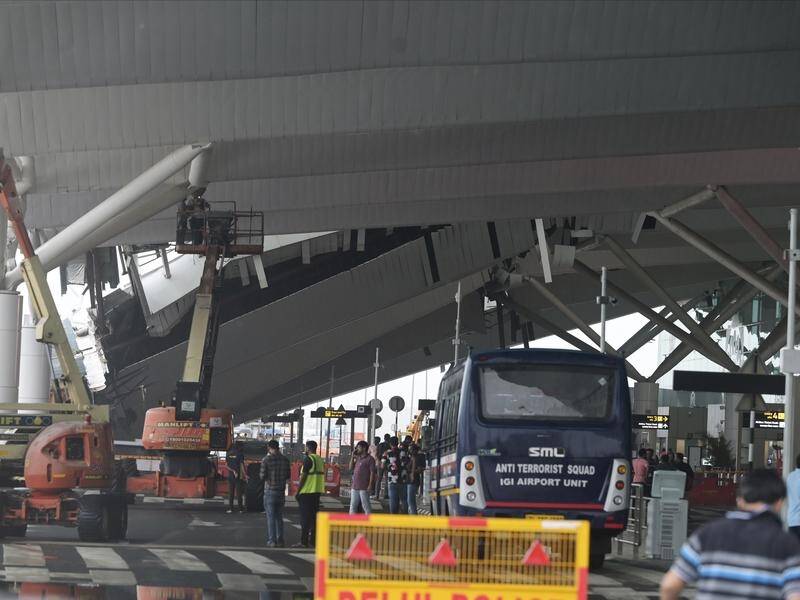 Crews work to clear debris after a roof collapse at New Delhi's international airport. (AP PHOTO)