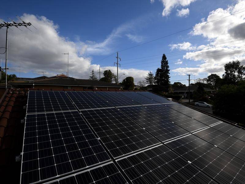 The base rate for rooftop solar owners who pump money into the power gird will drop by 32 per cent. (Dan Himbrechts/AAP PHOTOS)
