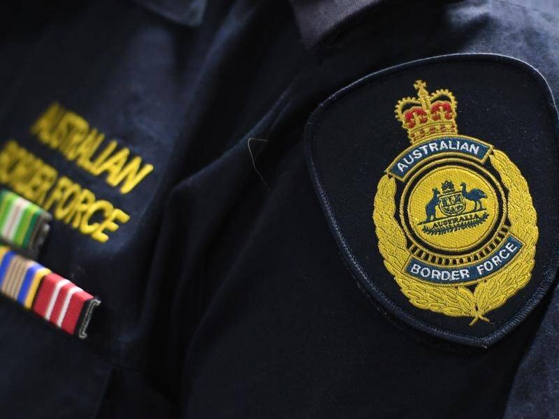 A man arrested at Brisbane airport allegedly had child abuse material on his phone. (Julian Smith/AAP PHOTOS)
