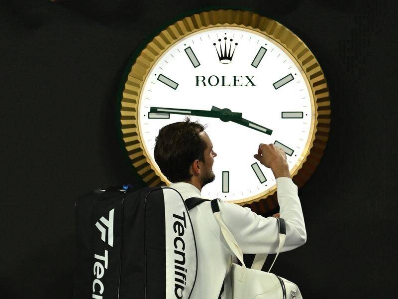 Daniil Medvedev walks wearily past the Melbourne Park clock after his epic win at 3.39am. (Lukas Coch/AAP PHOTOS)