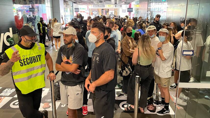 Huge queues of mask-wearing sports fans waiting for the official opening of JD Sports in Wollongong Central in October 2021. Picture by Adam McLean 
