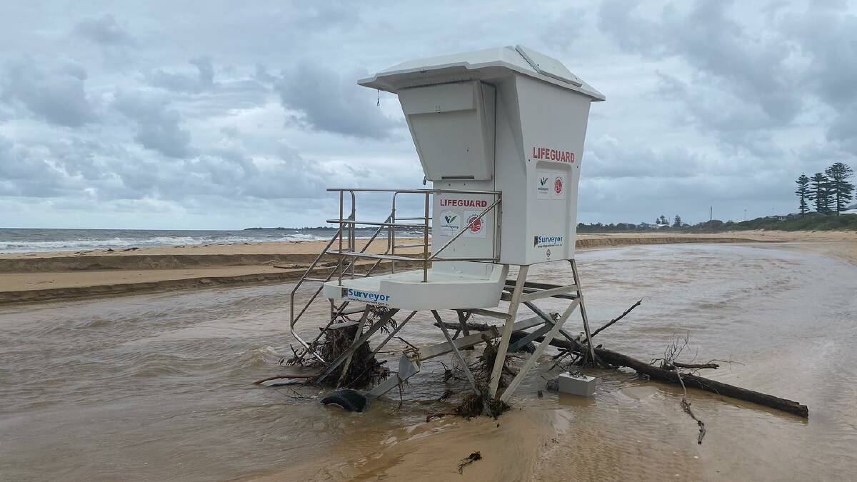 The bottom of council's lifeguard box at Bulli Beach was buried by sand during the wild weather. Picture by Bulli Surf Life Saving Club