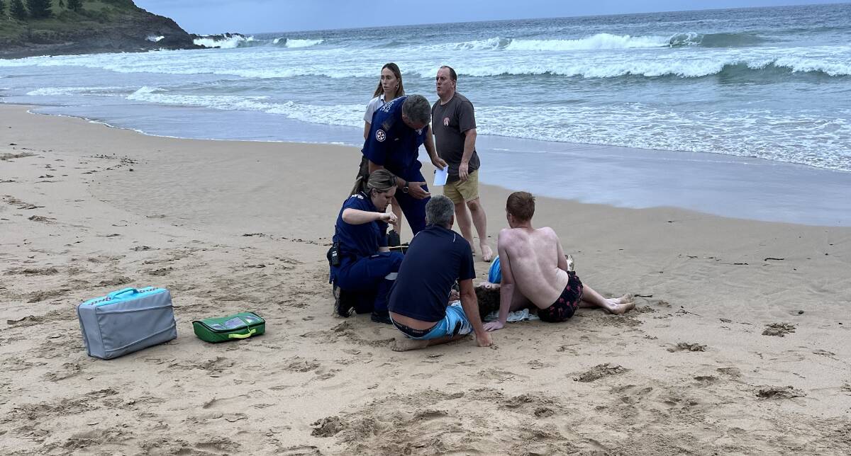 Paramedics treating the swimmer who was pulled in from the ocean at Jones Beach. Picture by Lucas Mak