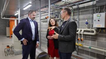 Ed Husic, industry and science minister, with Cunningham MP Alison Byrnes and Hysata CEO Paul Barrett at the company's manufacturing plant in Port Kembla. Picture by Sylvia Liber