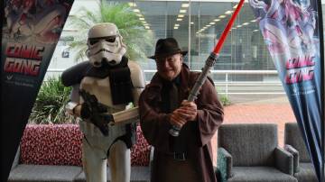 Wollongong Lord Mayor Gordon Bradbery wields a light sabre with his stormtrooper mate as the city gears up for another Comic Gong. Picture by Wollongong City Council