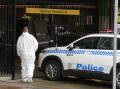 A forensics officer at the Wollongong train station car park. Picture by Robert Peet